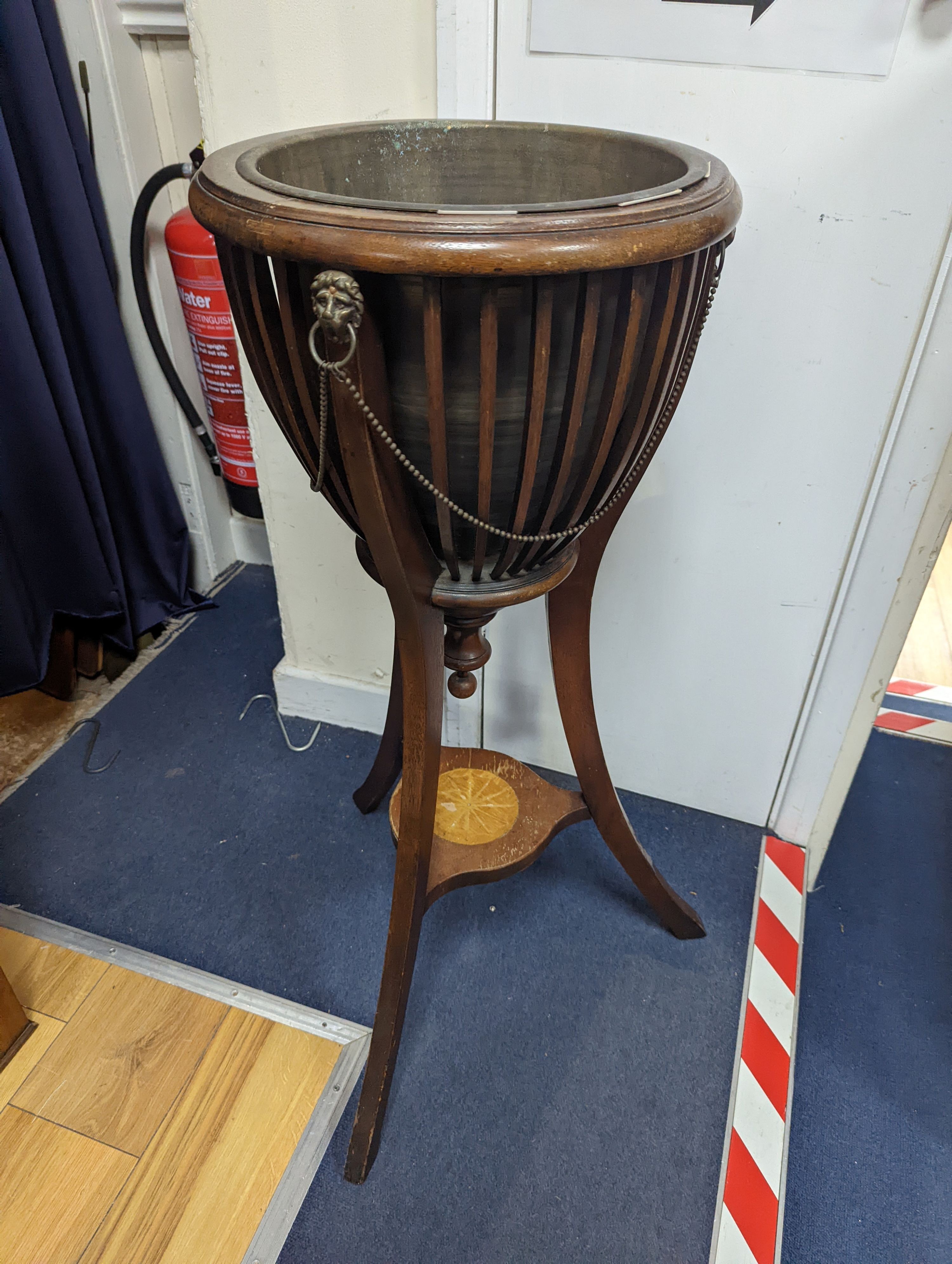 An Edwardian style inlaid mahogany jardiniere with brass liner, diameter 35cm, height 85cm